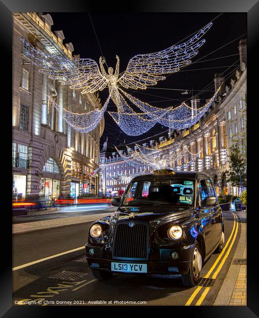 Taxi with Regent Street Christmas Lights in London, UK Framed Print by Chris Dorney