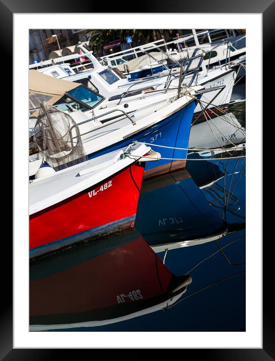 Boats reflecting in the water Framed Mounted Print by Jason Wells