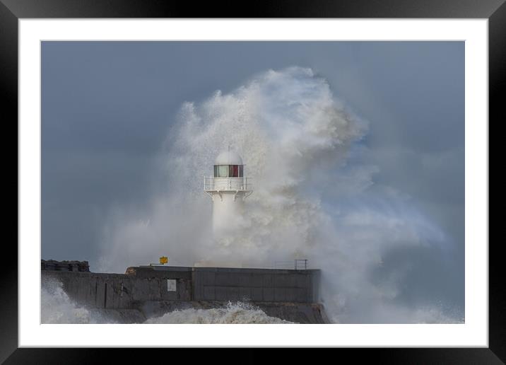 Lighthouse battered by stormy seas Framed Mounted Print by Kevin Winter