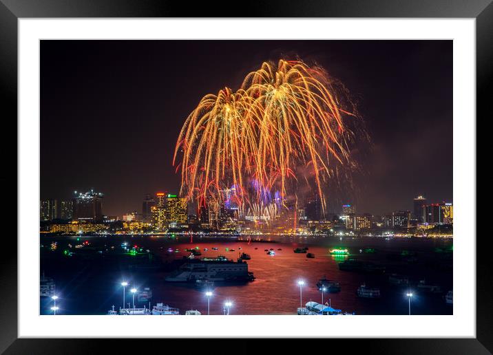 fantastic and colorful fireworks display over the night sky of the city during a festival Framed Mounted Print by Wilfried Strang