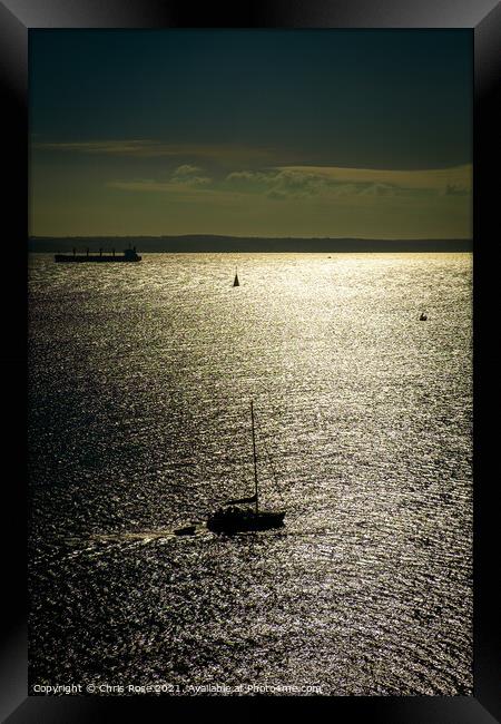 A silhouetted sailing boat Framed Print by Chris Rose