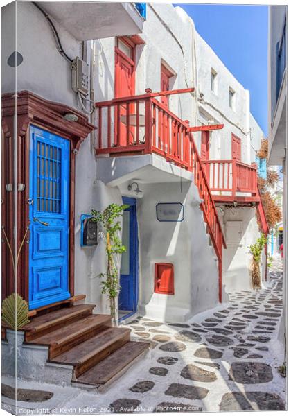 Typical street on the island of Mykonos, Greece Canvas Print by Kevin Hellon