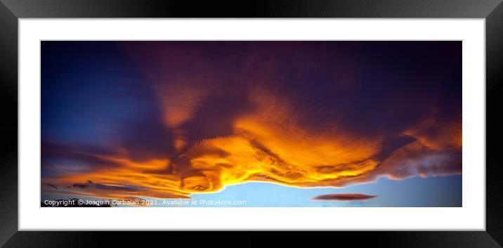 A large cloud with curious wavy shapes and warm reddish colors d Framed Mounted Print by Joaquin Corbalan
