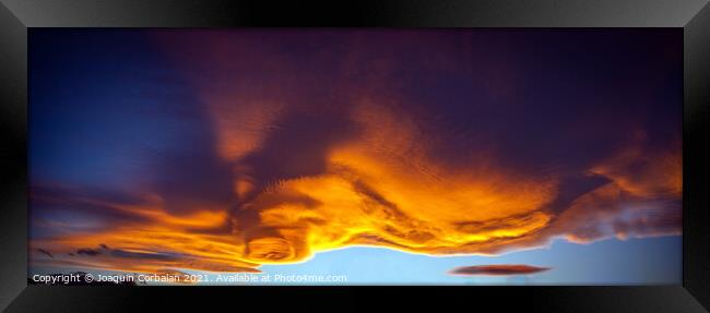 A large cloud with curious wavy shapes and warm reddish colors d Framed Print by Joaquin Corbalan