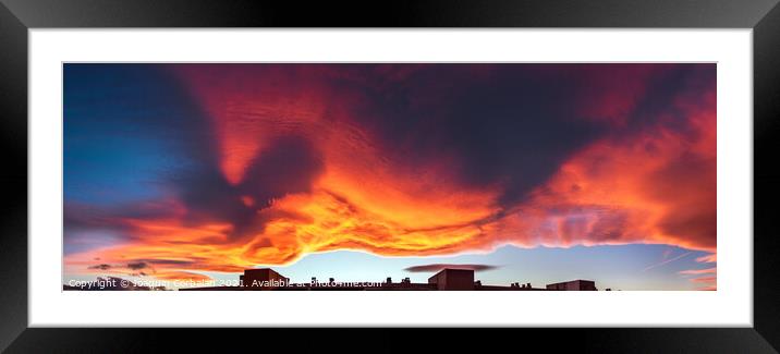 A large cloud with curious wavy shapes and warm reddish colors d Framed Mounted Print by Joaquin Corbalan