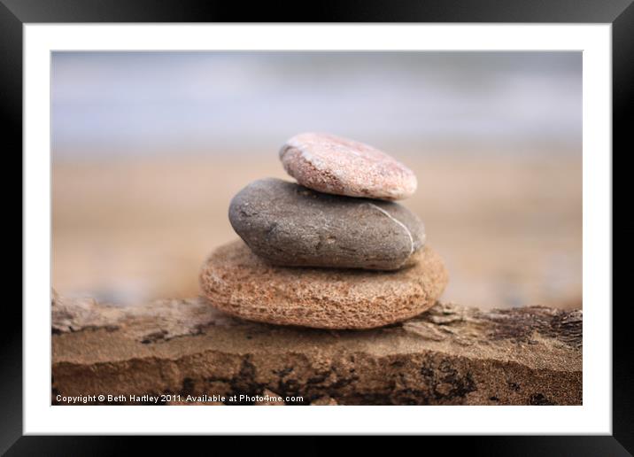 Pebble stack on drift wood Framed Mounted Print by Beth Hartley