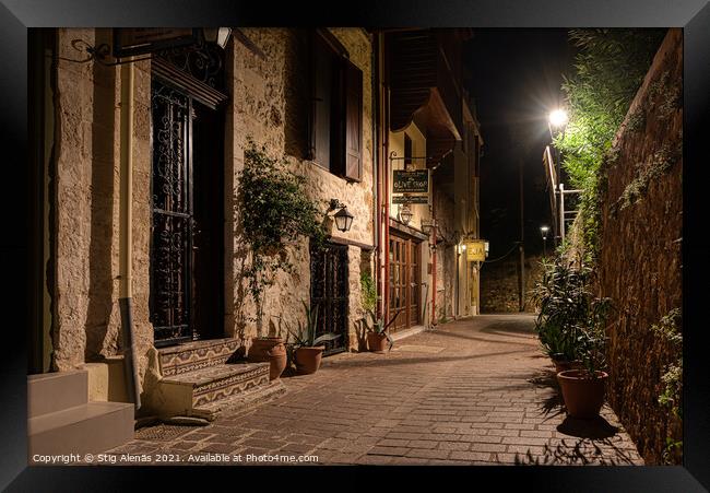 dark alley lit by a streetlight in the old town of Chania Framed Print by Stig Alenäs