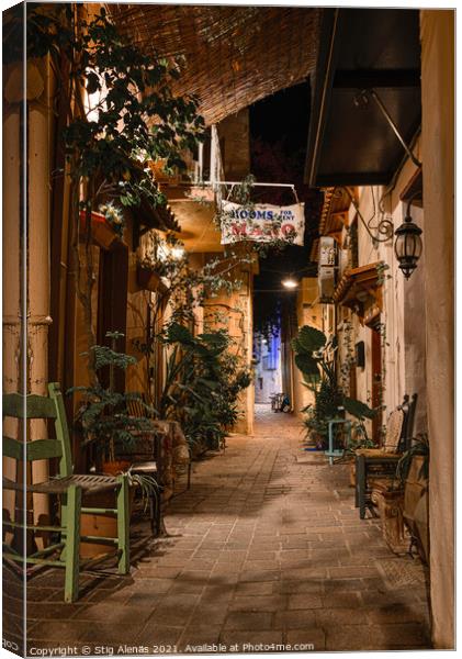 Alleyway in the old town of Chania with chairs and green plants  Canvas Print by Stig Alenäs