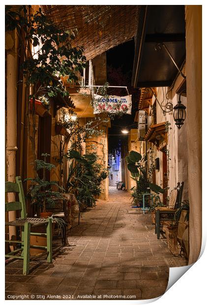 Alleyway in the old town of Chania with chairs and green plants  Print by Stig Alenäs