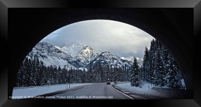 A view of snow covered mountains and roads through an arch. Framed Print by PhotOvation-Akshay Thaker