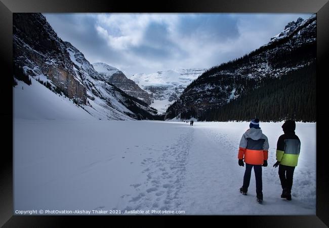 Tourists kids are walking on top of the frozen lake Louise Canadian and Tourists are enjoying winter Framed Print by PhotOvation-Akshay Thaker