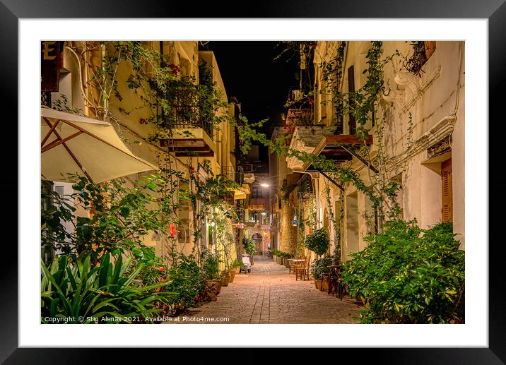 an illuminated alley with green plants and balconies on the side Framed Mounted Print by Stig Alenäs