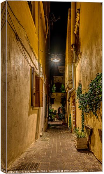 a dark alley in the old town of Chania, illuminated with a lamp  Canvas Print by Stig Alenäs