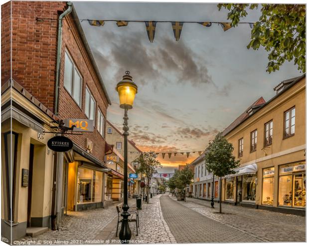 pedestrian shopping street in Ystad with a streetlight an early  Canvas Print by Stig Alenäs