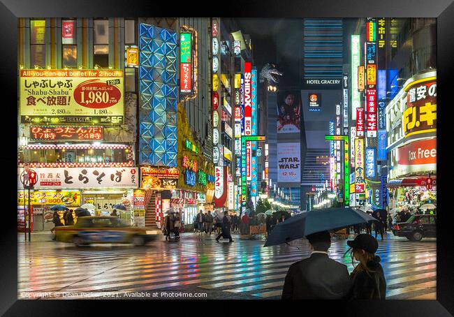 Tokyo Nightscape in the Rain Framed Print by Dean Packer