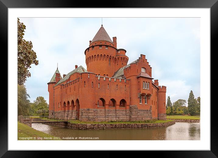 a romantic red castle with a tall tower surrounded by a moat Framed Mounted Print by Stig Alenäs