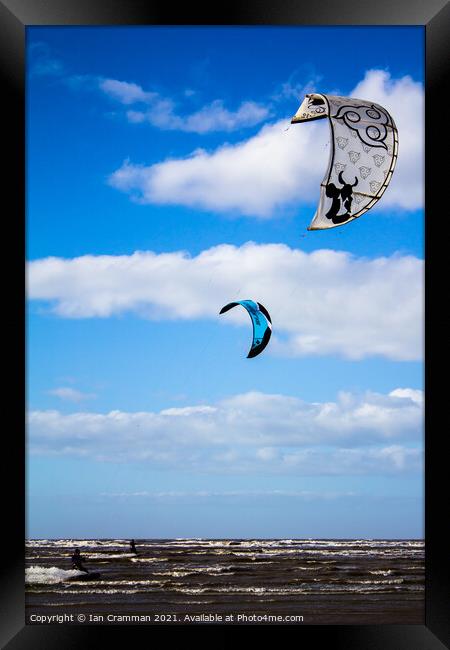 Kite-surfers on the water Framed Print by Ian Cramman