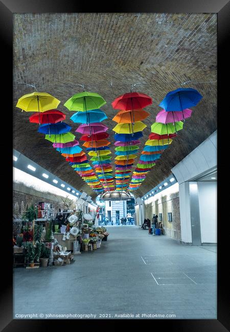 An array of colourful umbrellas at London Bridge Station. Framed Print by johnseanphotography 
