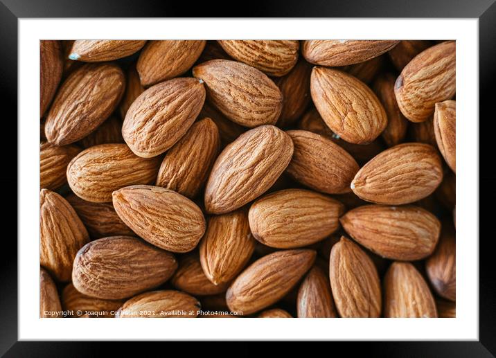 Close detail of a pile of raw almonds nuts with peel Framed Mounted Print by Joaquin Corbalan