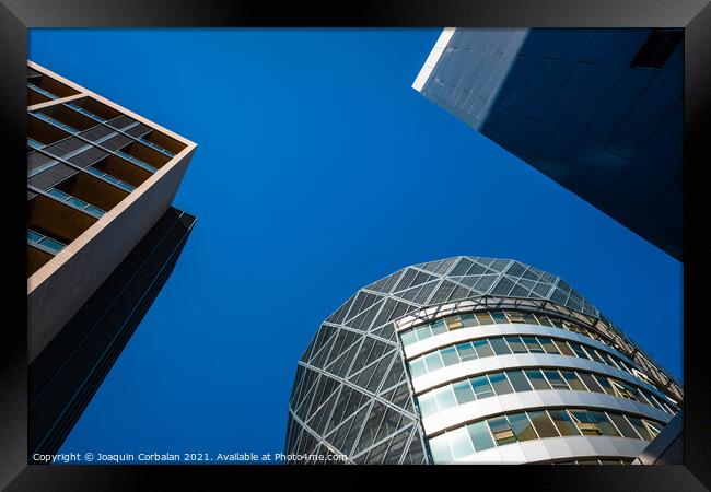 Tall office buildings, viewed from below, modern and rounded, wi Framed Print by Joaquin Corbalan