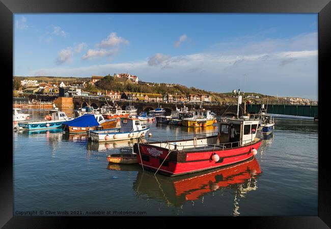 Fishing boats at high tide Framed Print by Clive Wells