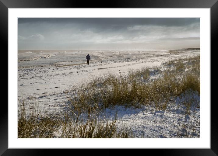 Person walking on a snowy beach Framed Mounted Print by GILL KENNETT
