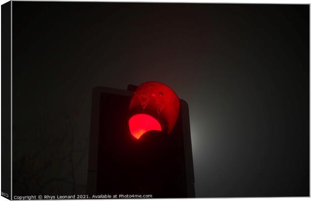 A british traffic light shines red, indicating sto Canvas Print by Rhys Leonard