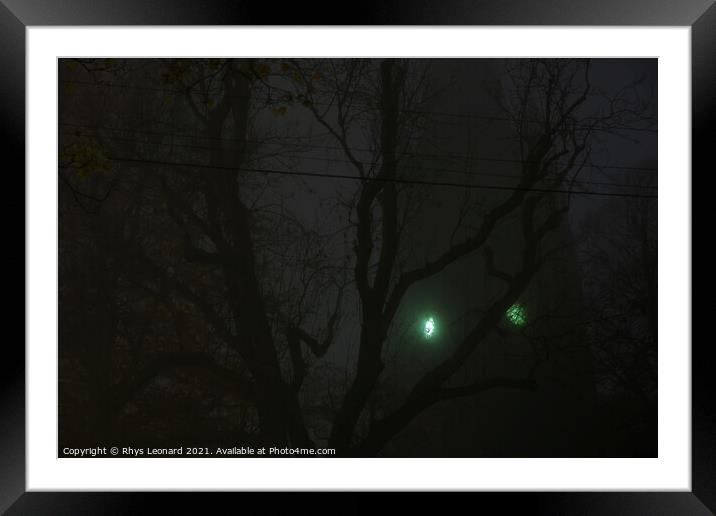 Eerie green clock face on a church tower shines through thick fog Framed Mounted Print by Rhys Leonard