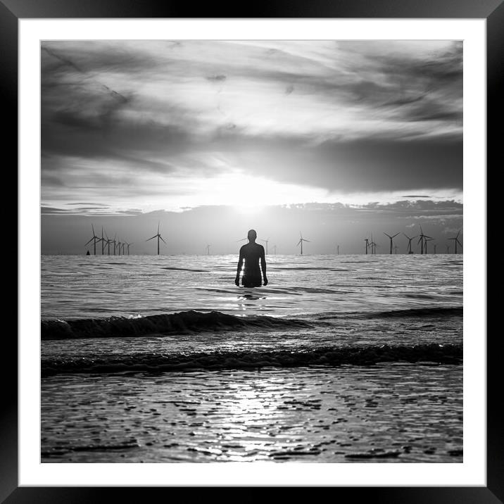 Silhouette of an Iron Man at sunset Framed Mounted Print by Jason Wells