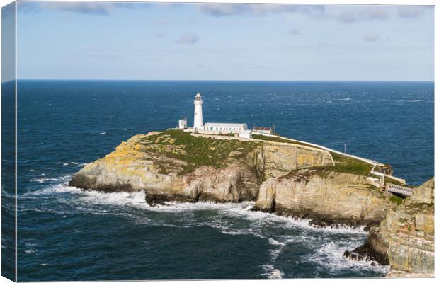 Waves crash around South Stack Lighthouse Canvas Print by Jason Wells