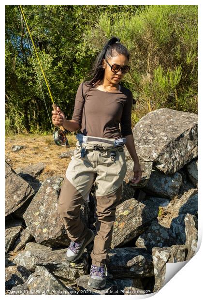 An asian women walking along a rocky river back while fly fishing in the summer Print by SnapT Photography