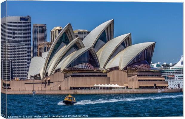 A boat powers past the Sydney Opera House, in the  Canvas Print by Kevin Hellon