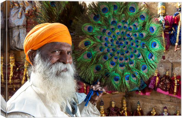 Peacock fan Seller at Jaisalmer Fort, India. Canvas Print by Chris North