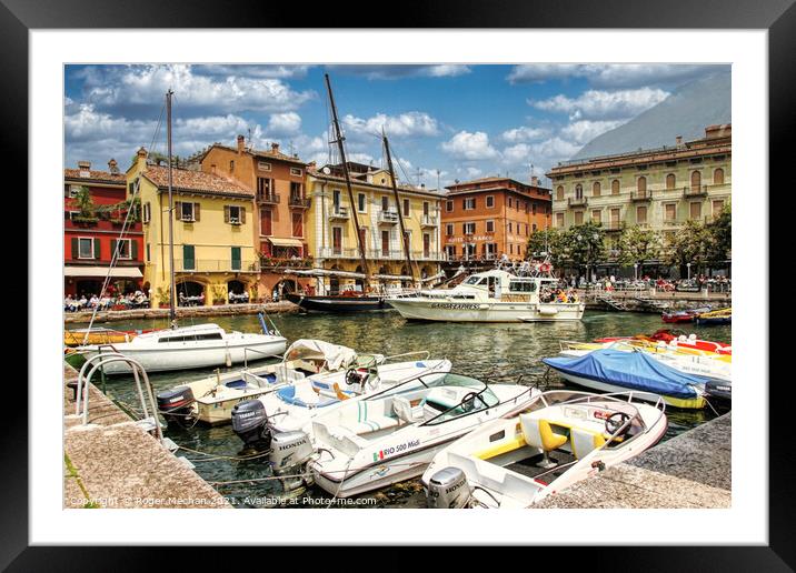 Earth-toned houses and classic boats at Malcesine  Framed Mounted Print by Roger Mechan