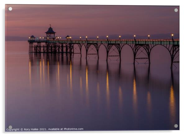 Clevedon Pier with lights reflecting onto a calm sea Acrylic by Rory Hailes