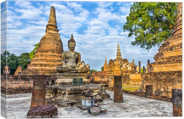 Buddha statue with Wat Mahathat in the background Canvas Print by Kevin Hellon