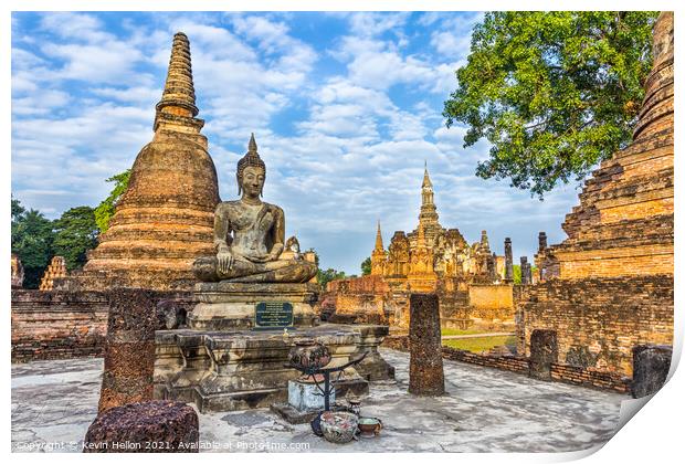 Buddha statue with Wat Mahathat in the background Print by Kevin Hellon