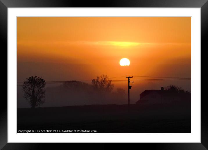 Misty orange sunrise  Framed Mounted Print by Les Schofield
