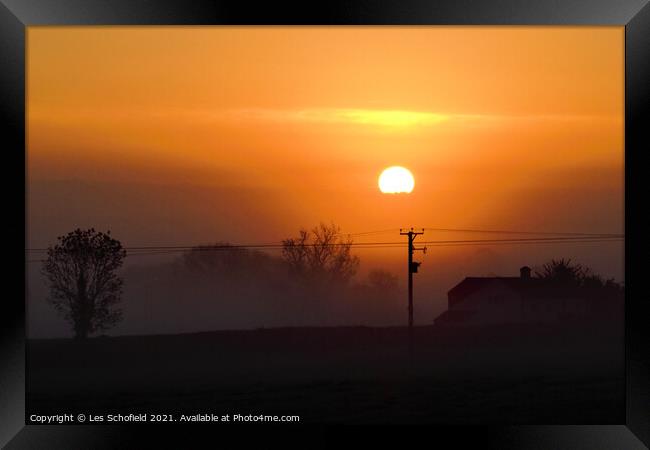 Misty orange sunrise  Framed Print by Les Schofield