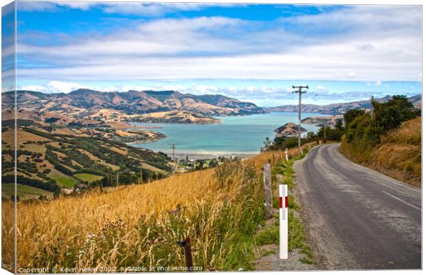 Road through the grasslands and hills of Akaroa Canvas Print by Kevin Hellon