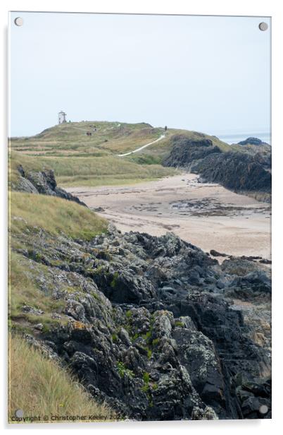 Rocky beach and lighthouse of Ynys Llanddwyn Acrylic by Christopher Keeley