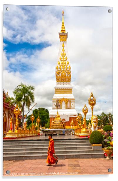 A monml walks past the spire in Wat Phra That Phanom Acrylic by Kevin Hellon