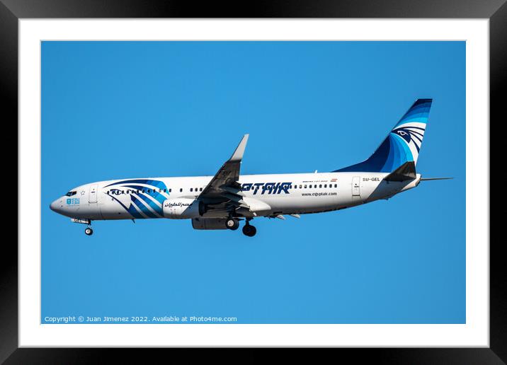 Boeing 737-800 passenger aircraft of the airline Egyptair flying before landing against sky Framed Mounted Print by Juan Jimenez