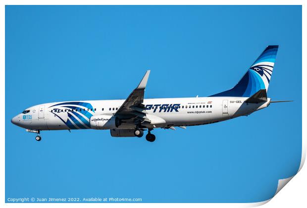 Boeing 737-800 passenger aircraft of the airline Egyptair flying before landing against sky Print by Juan Jimenez
