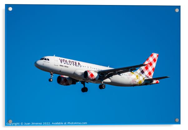Airbus A320 passenger aircraft of the airline Volotea flying before landing against sky Acrylic by Juan Jimenez