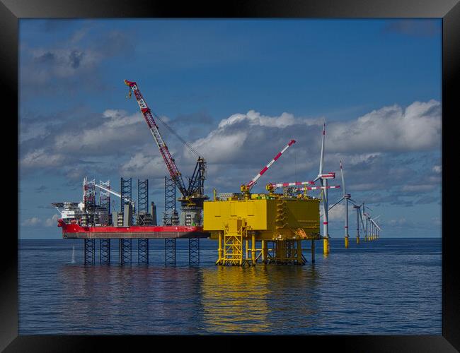 Offshore jackup installing turbine blades Framed Print by Russell Finney