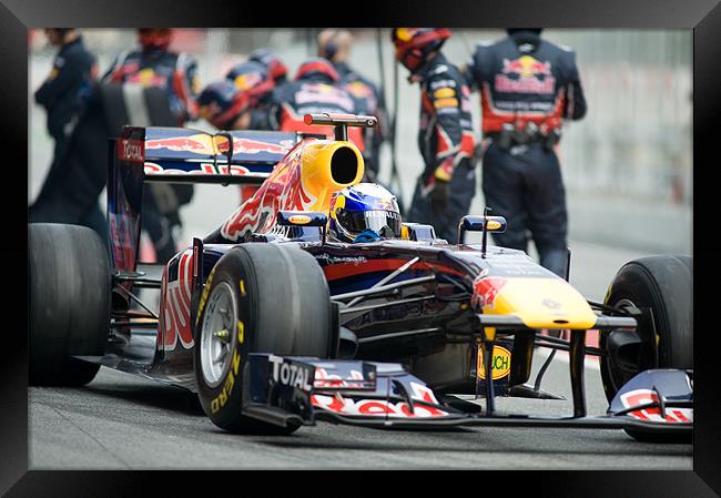 Sebastian Vettel leaving the pits Framed Print by SEAN RAMSELL