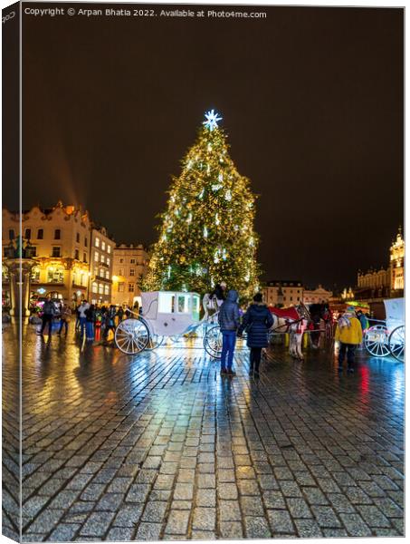 Krakow, Poland - January 08, 2022: Tourists in front of horse carriage against Christmas tree in the city center during night, City xmas decoration concept Canvas Print by Arpan Bhatia