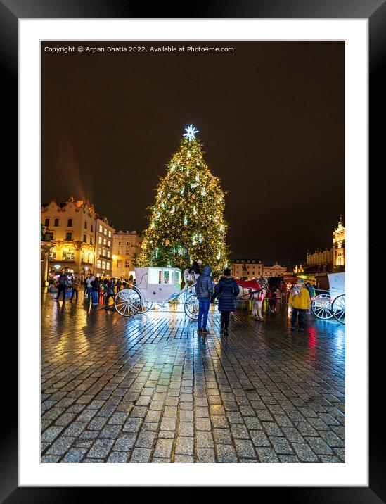 Krakow, Poland - January 08, 2022: Tourists in front of horse carriage against Christmas tree in the city center during night, City xmas decoration concept Framed Mounted Print by Arpan Bhatia