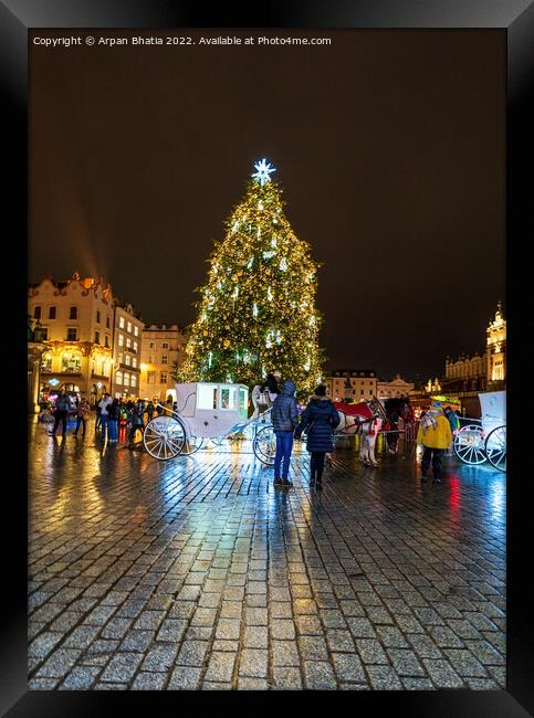 Krakow, Poland - January 08, 2022: Tourists in front of horse carriage against Christmas tree in the city center during night, City xmas decoration concept Framed Print by Arpan Bhatia